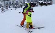 Aller Anfang ist schwer: Ein Begleitsportler stützt eine junge Teilnehmerin  bei ihren ersten Versuchen Ski zu fahren